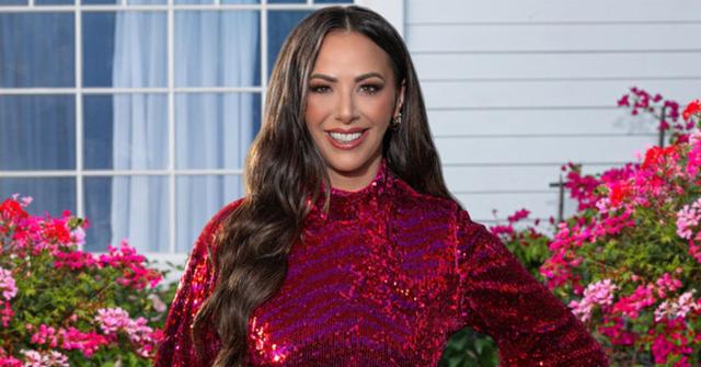 Kristen Doute posing in front of a house smiling in 'The Valley' promo