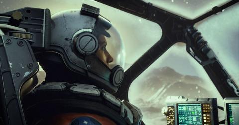 A character from Starfield sitting in an aircraft with a helmet on.