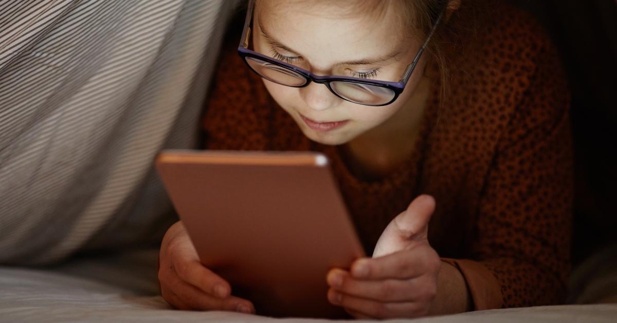 Young woman reading from a tablet.