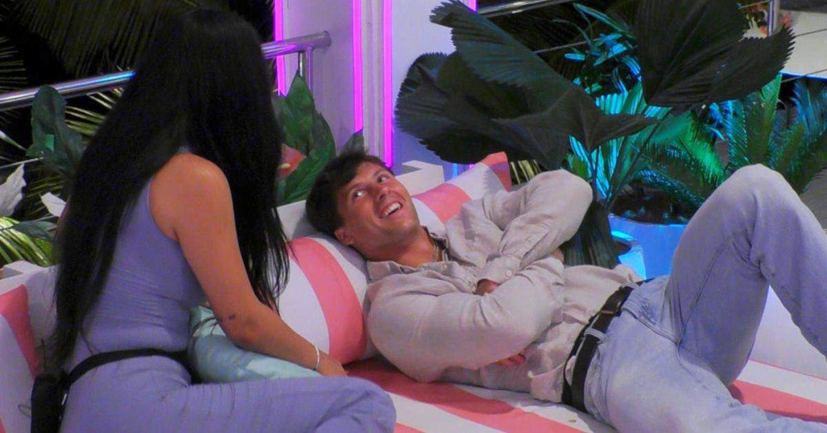 Leah Kateb and Rob Rausch lay on a daybed and chat in Season 6 of 'Love Island USA.'