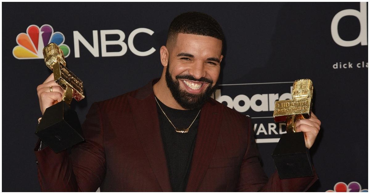 Drake holding his trophies at the Billboard Music Awards