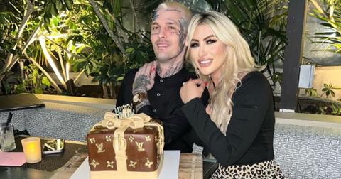 Melanie Martin and Aaron Carter pose in front of a cake in June 2022