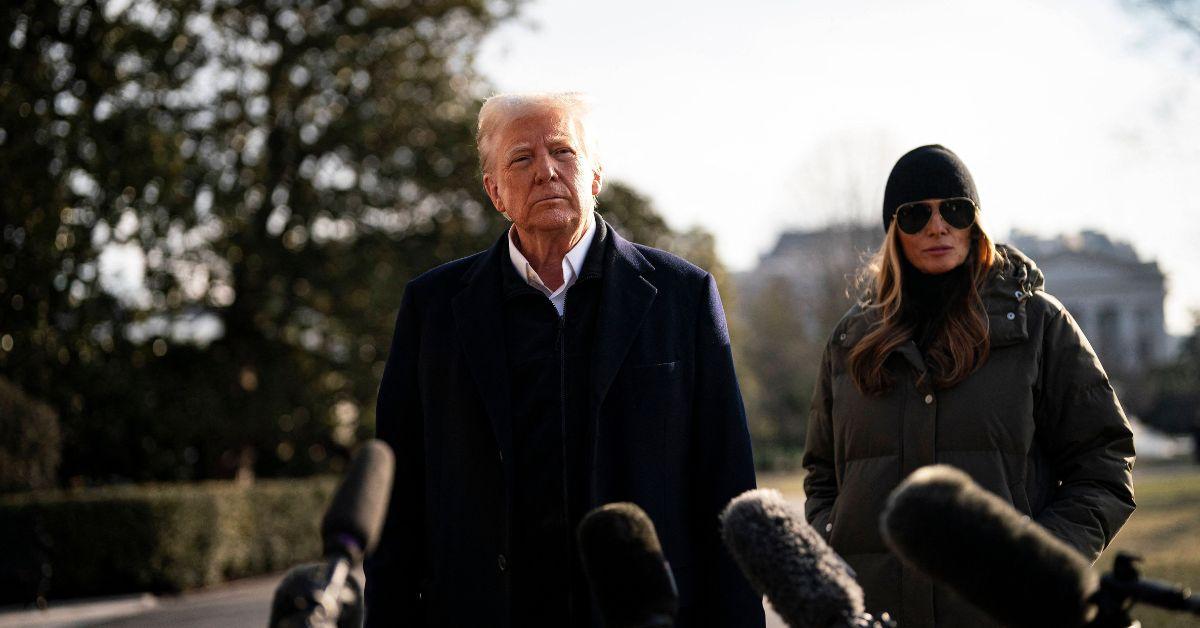 Donald and Melania Trump in front of microphones. 