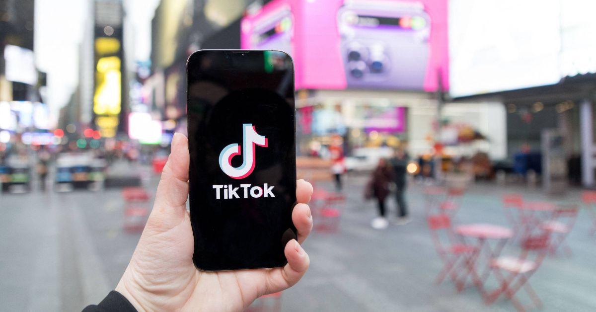 A TikTok logo on a phone in Times Square. 