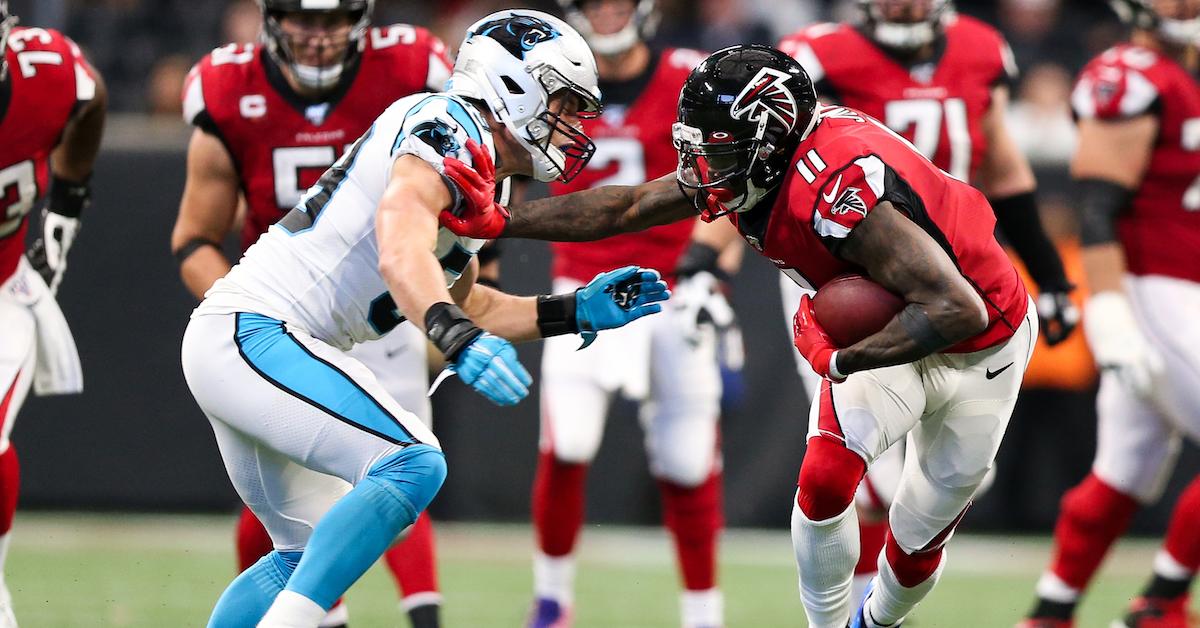 Julio Jones #11 of the Atlanta Falcons pushes off Luke Kuechly #59 of the Carolina Panthers during the second half of the game at Mercedes-Benz Stadium on December 8, 2019 in Atlanta