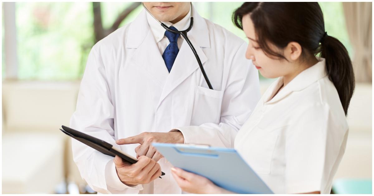 A doctor speaking to a nurse in an office