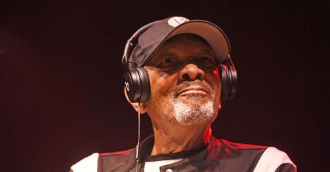 Roy Ayers wearing headphones performing on stage.