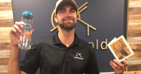 Ronald Gladden holding a water bottle and a card
