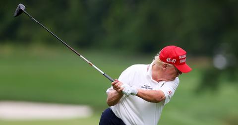 Donald Trump in the middle of a golf swing.