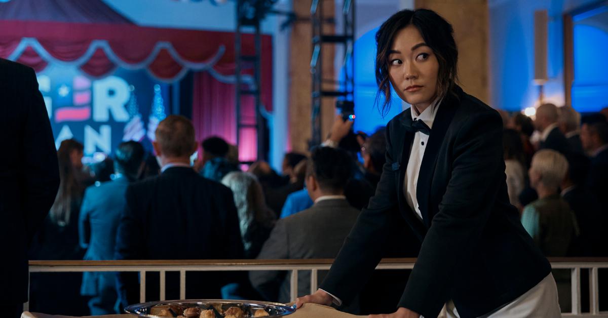 Kimiko (Karen Fukuhara) wearing a tuxedo and rolling a tray of food while looking over her shoulder in 'The Boys' Season 4.