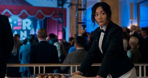 Kimiko (Karen Fukuhara) wearing a tuxedo and rolling a tray of food while looking over her shoulder in 'The Boys' Season 4.