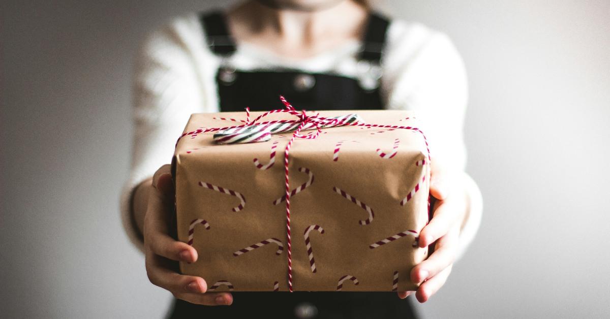 A girl holding a Christmas present.