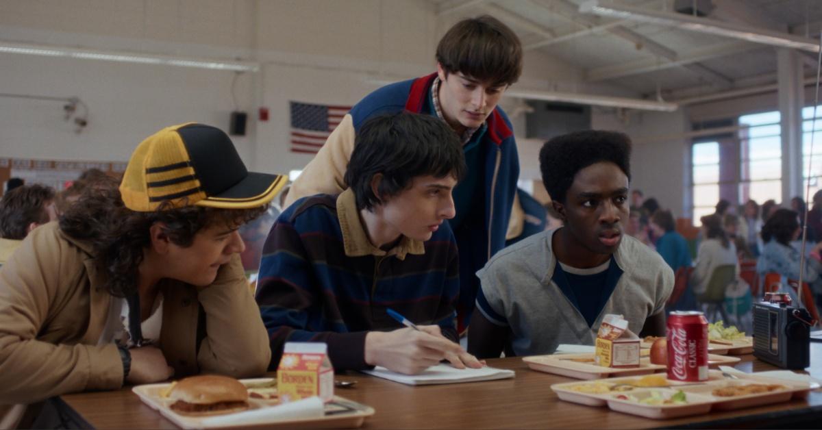 The several cast members of "Stranger Things" film a scene. 