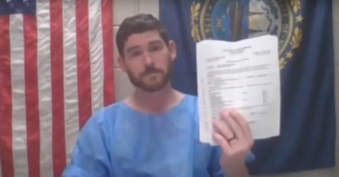 Erik Conover holds up paperwork at his arraignment