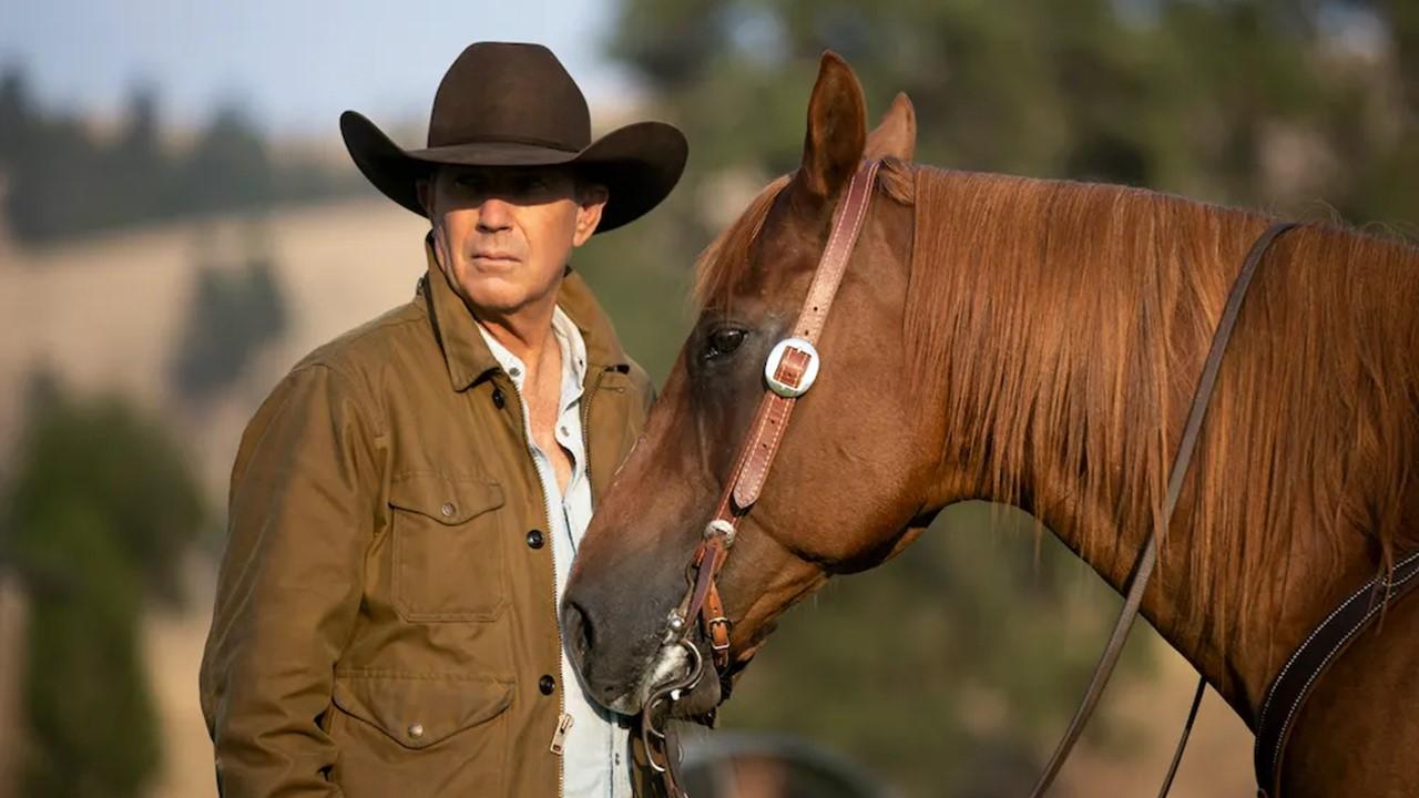 Kevin Costner standing next to a horse on 'Yellowstone'