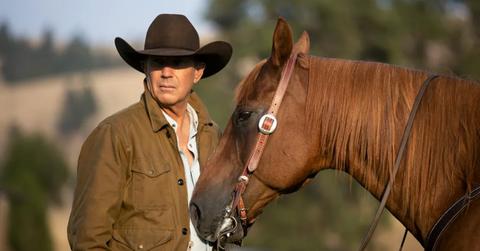 Kevin Costner standing next to a horse on 'Yellowstone'