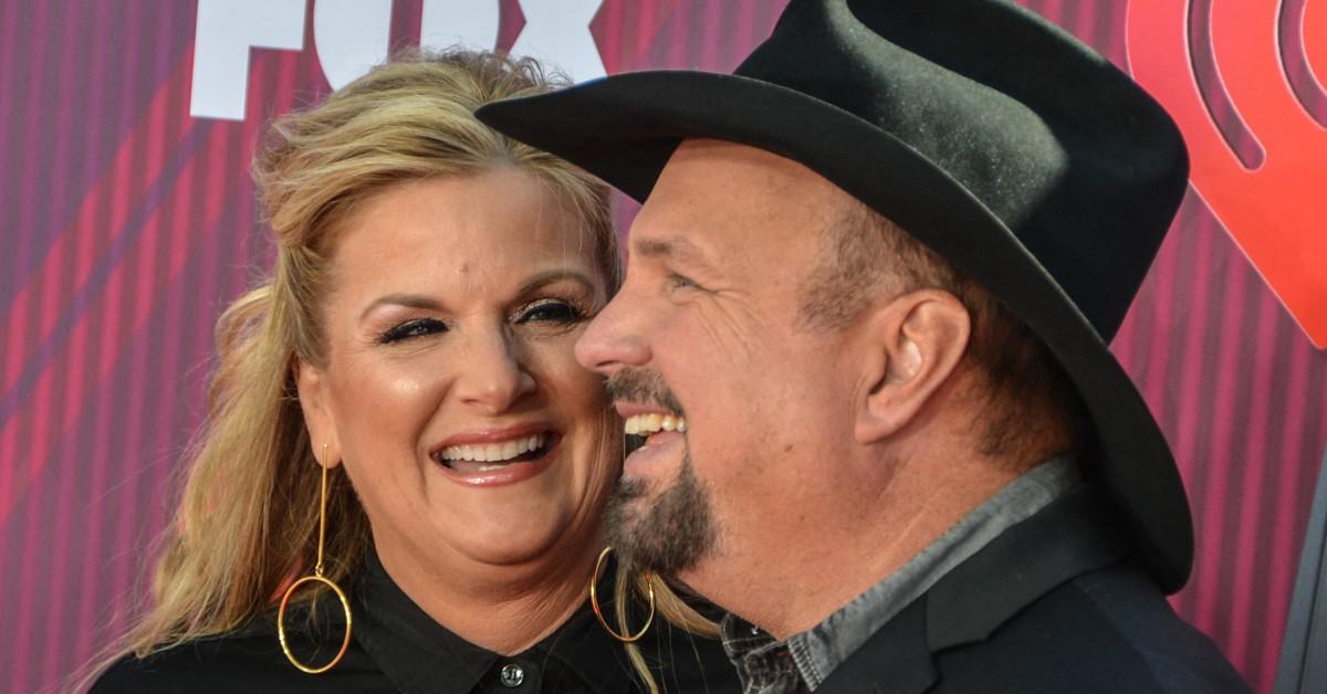 Trisha Yearwood and Garth Brooks laughing together in a photo