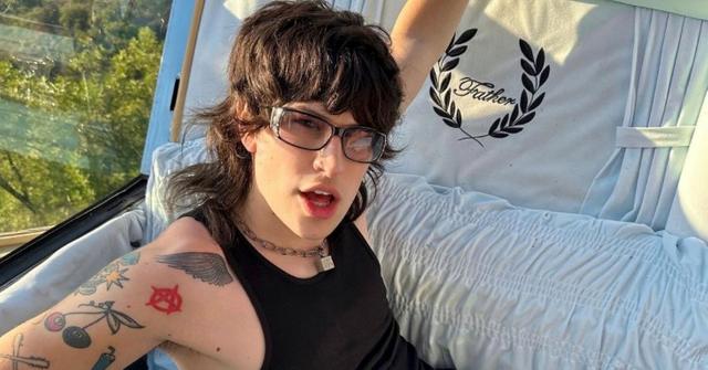 Jake Webber sitting in a coffin