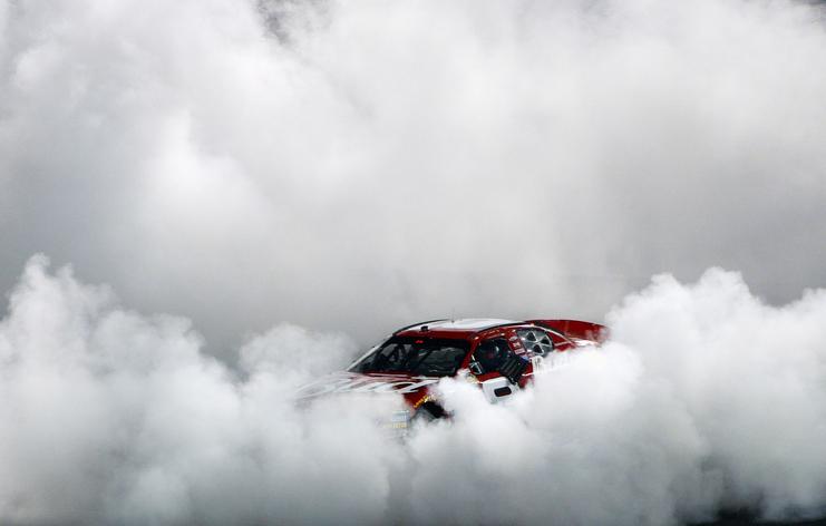 Action shot of Dale Earnhardt Jr. driver of the #8 Budweiser Chevrolet celebrates with a victory burnout