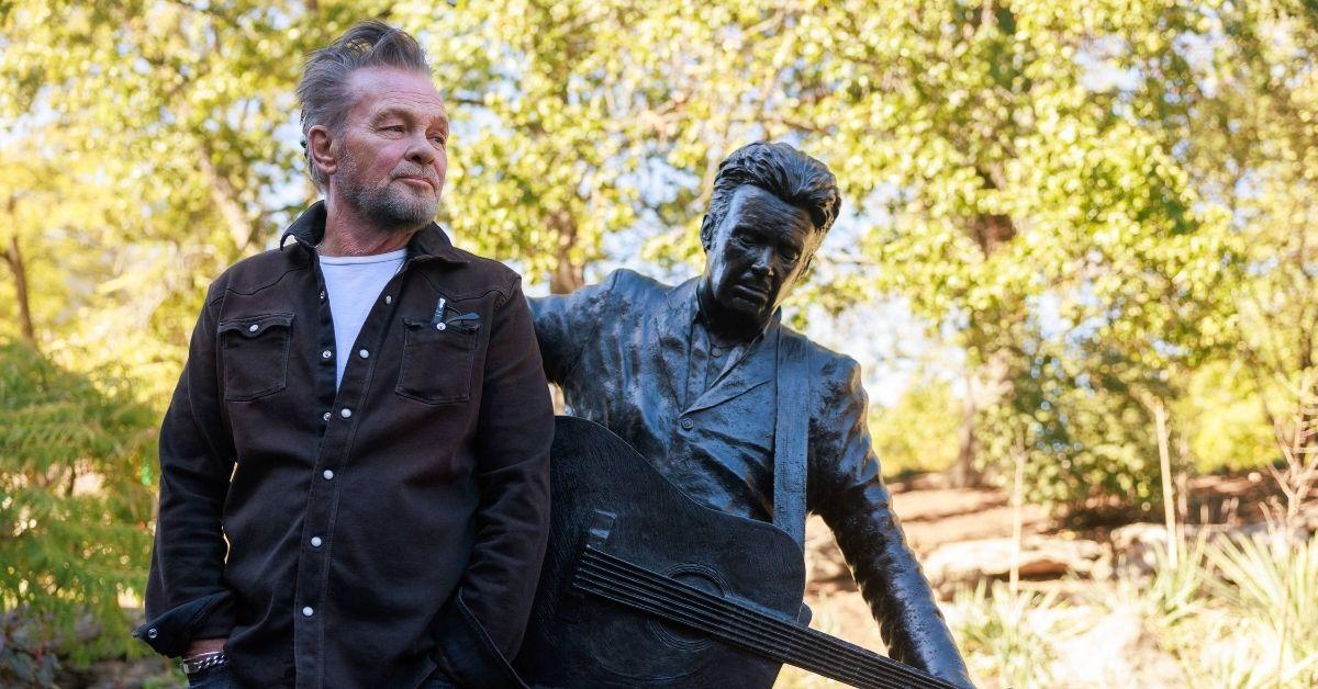 John Mellencamp with a statue honoring him at Indiana University
