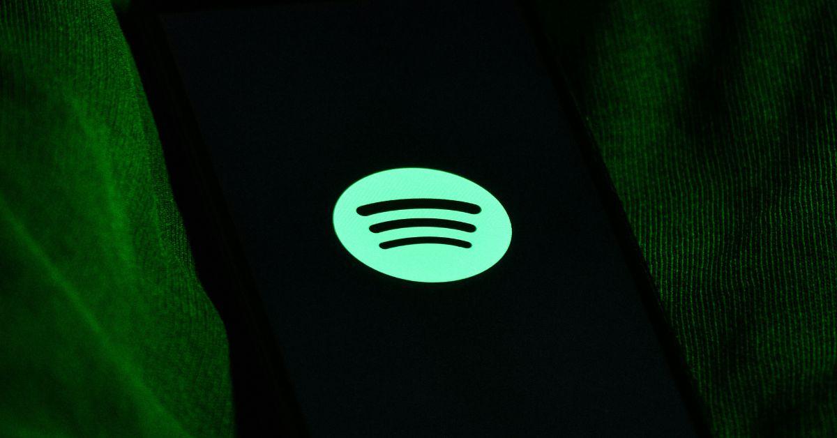 The Spotify logo on a phone. 