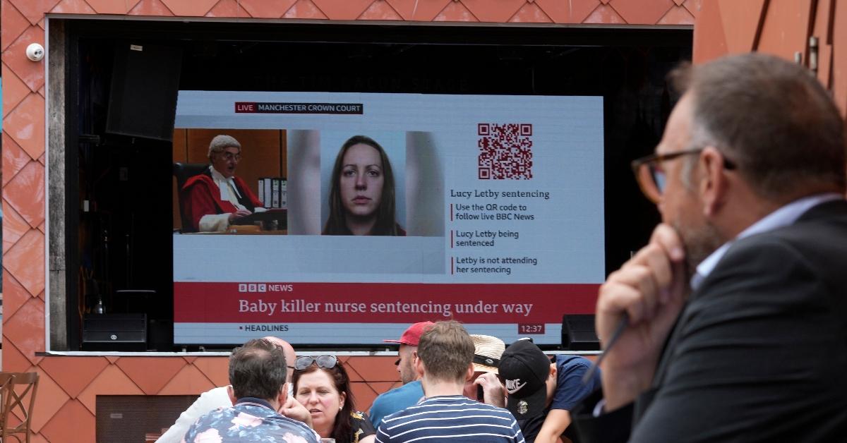 A large television screen near Manchester Crown Court broadcasts the judge sentencing convicted hospital nurse Lucy Letby