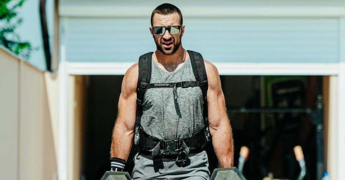 Lazar Dukic walking with backpack while holding weights