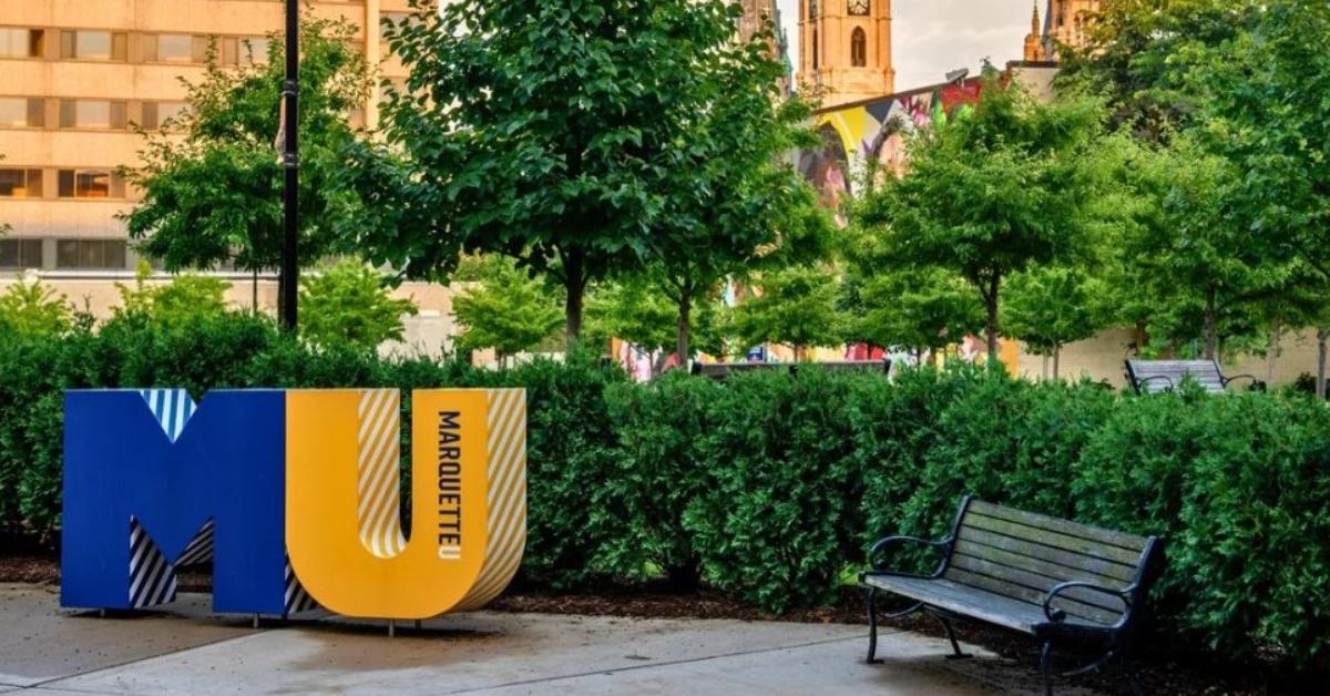 A shot of a bench and sign at Marquette University.