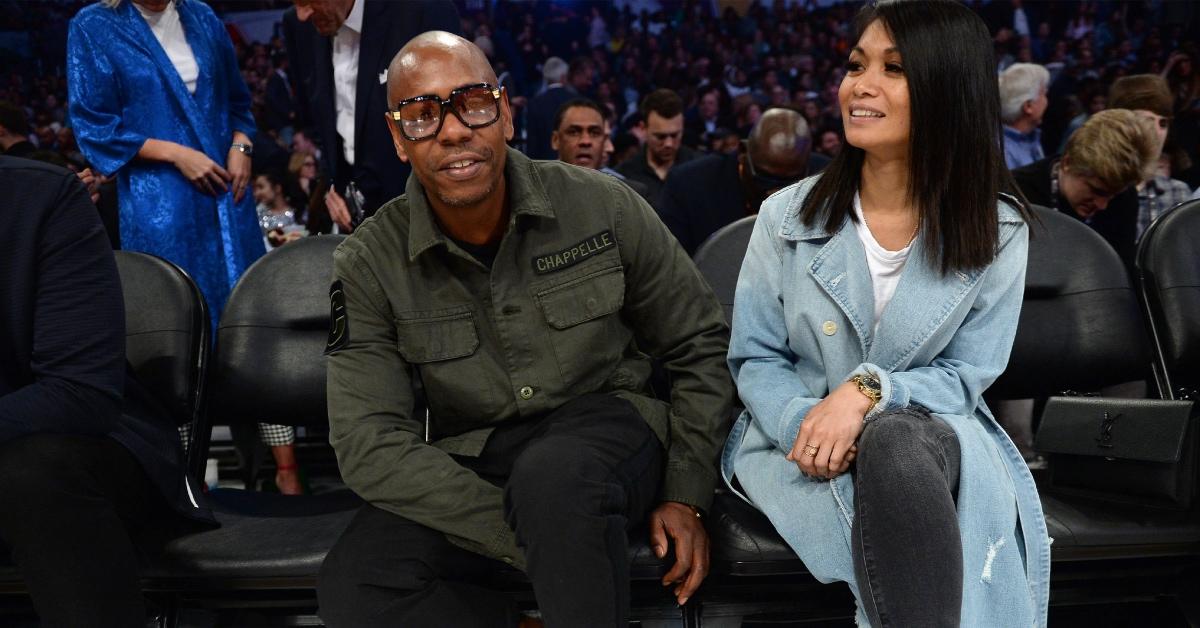 Dave Chappelle and his wife Elaine sit courtside.