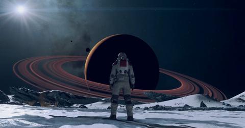 'Starfield' Close-up of man in spacesuit standing on a moon.