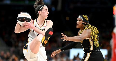 Caitlin Clark #22 of the Indiana Fever handles the ball against Aaliyah Edwards #24 of the Washington Mystics
