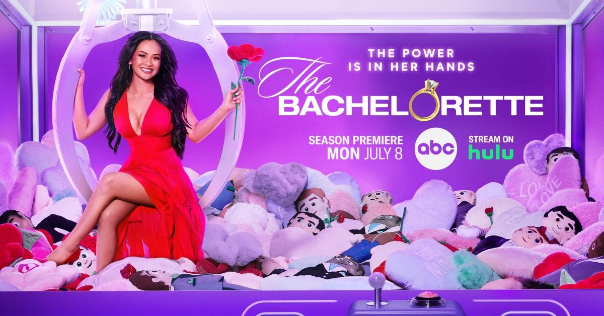 'The Bachelorette' Season 21 official key art features Jenn Tran in a red dress holding a rose while hanging on a claw in a claw machine full of male plushies.