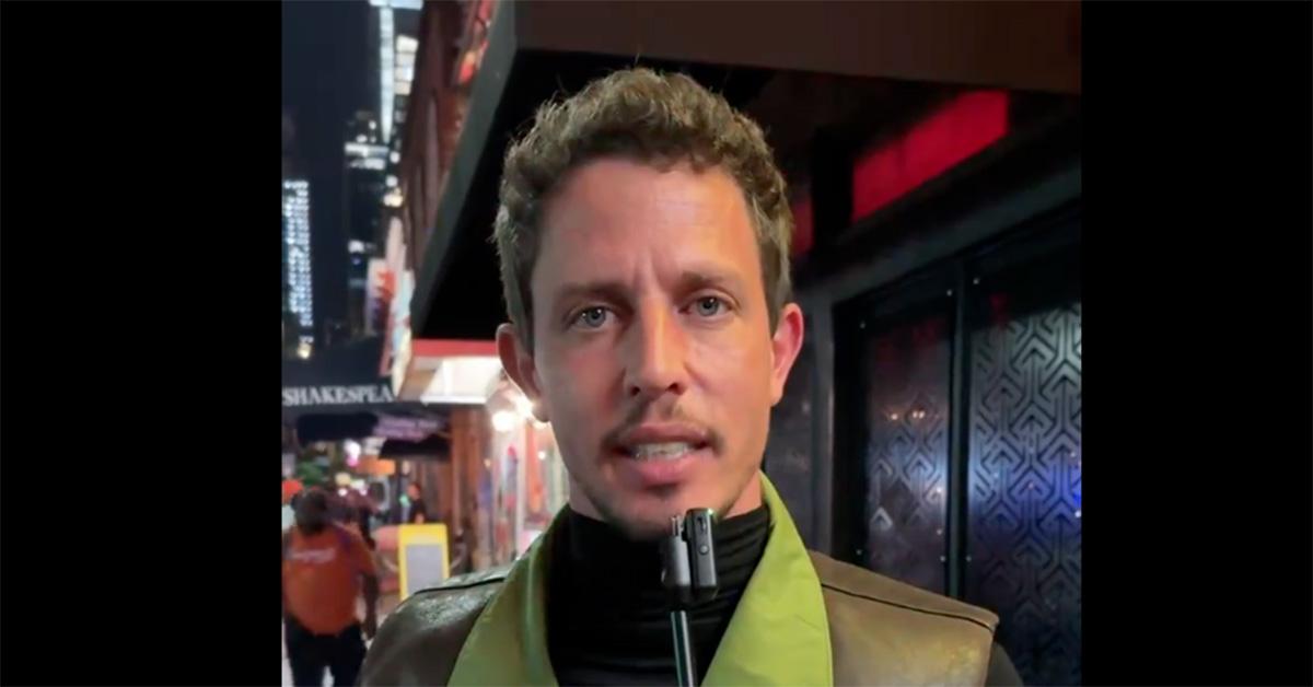 Tony Hinchcliffe holding a mic up in New York City. 