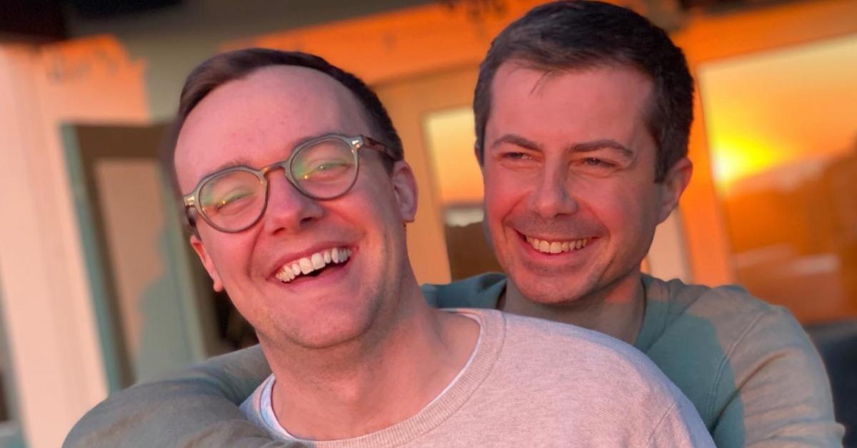 Pete and Chasten Buttigieg smiling while watching the sunset.