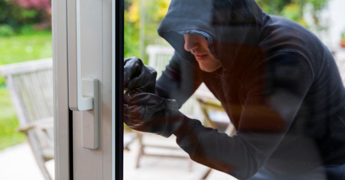 burglar using special tools to break in a house picture id