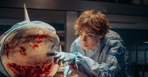 Sophia studying a shark in 'Under Paris'