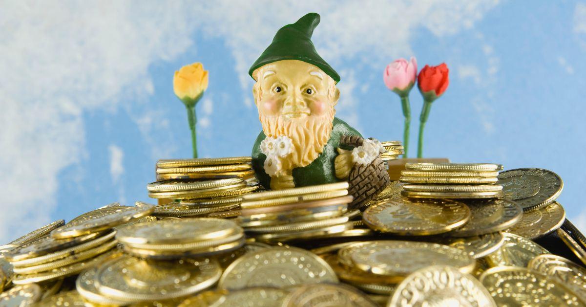 A gnome figurine in the middle of a pile of gold coins 