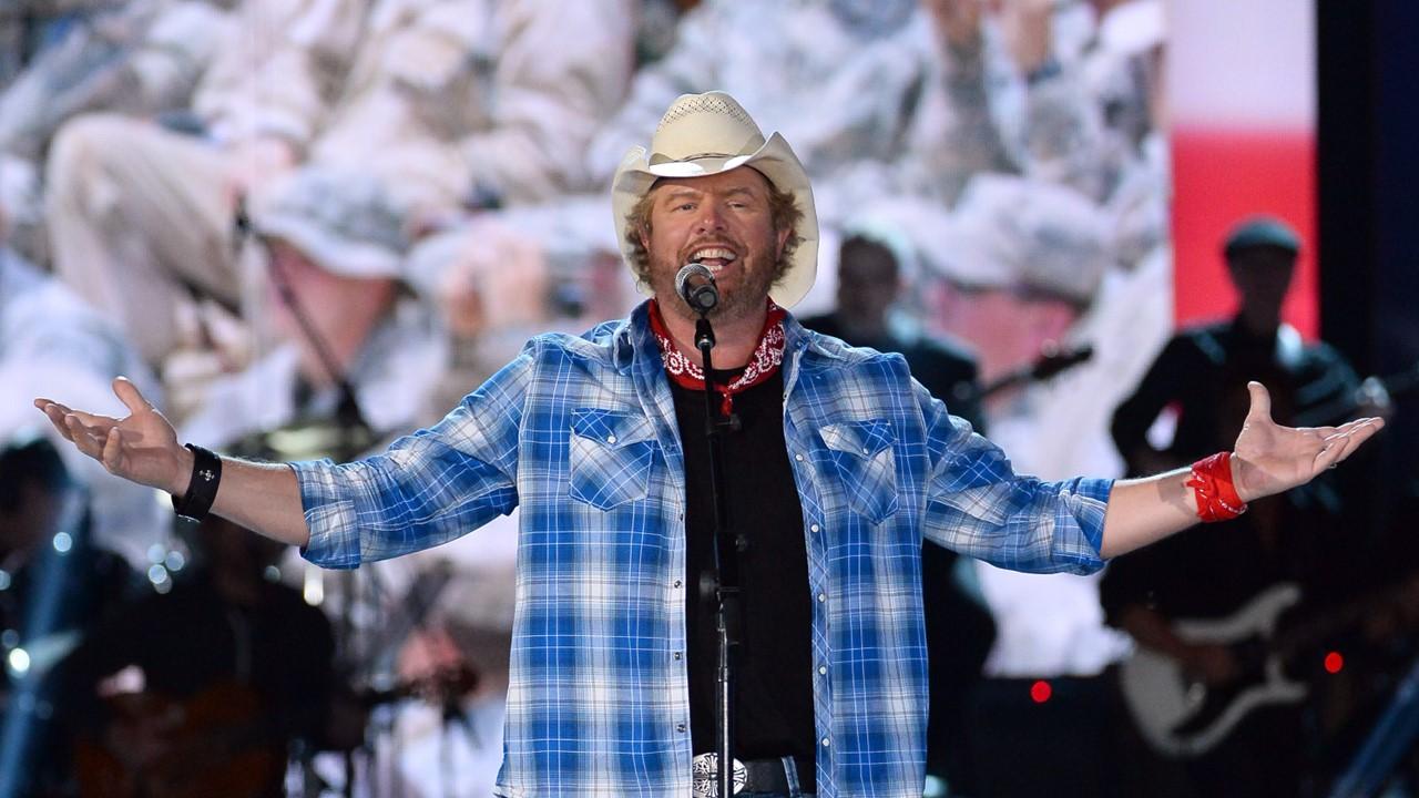 Toby Keith accepts USO award onstage during ACM Presents: An All-Star Salute to the Troops on April 7, 2014