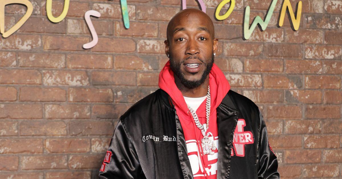 Freddie Gibbs in a black jacket and red hoodie in 2017