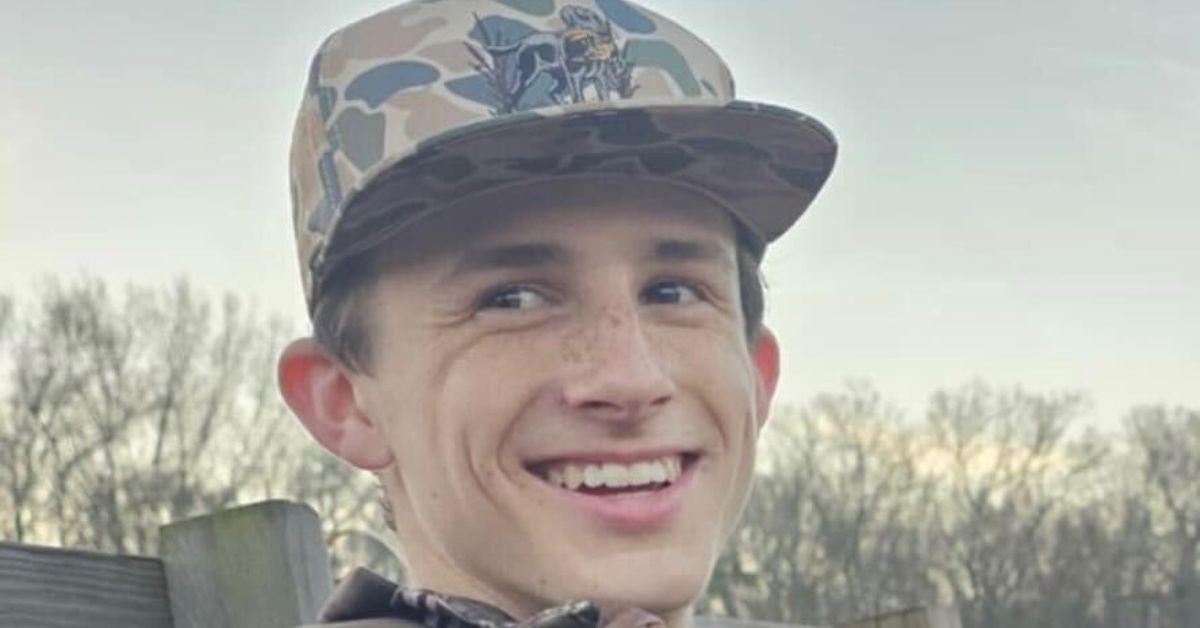 Miller Gardner in a camo hat in the woods. 