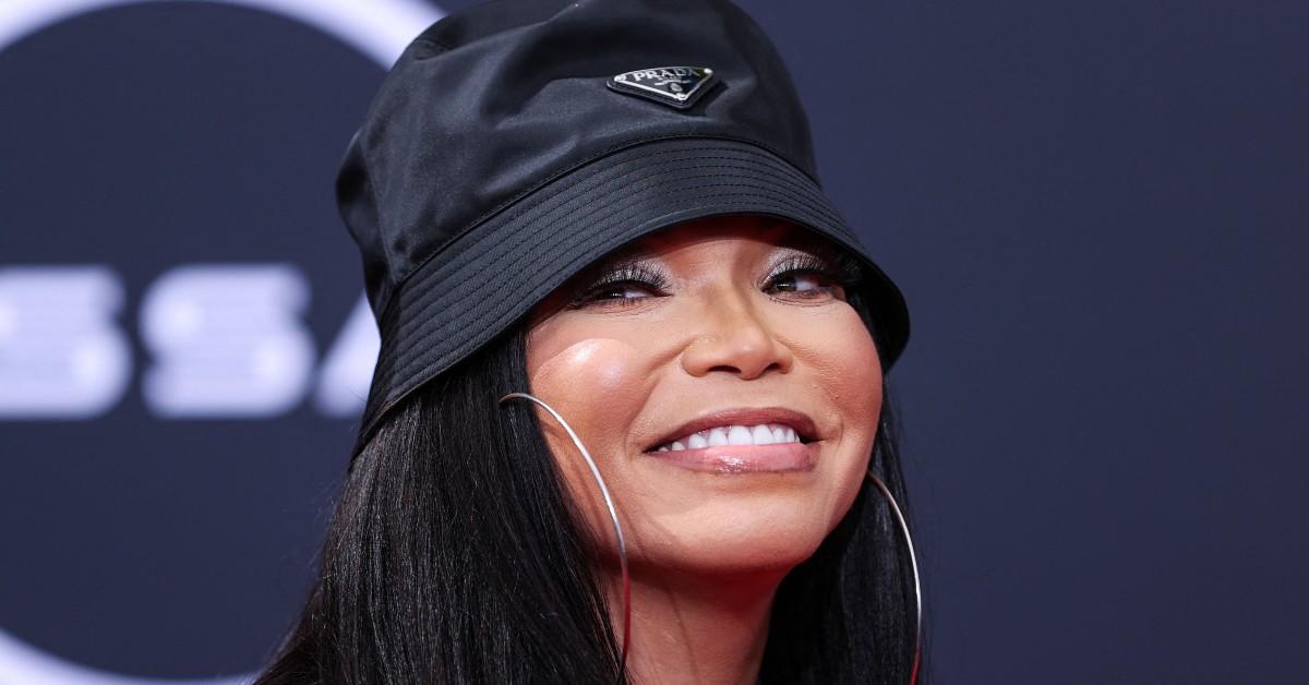 Tisha Campbell smiling in a hat