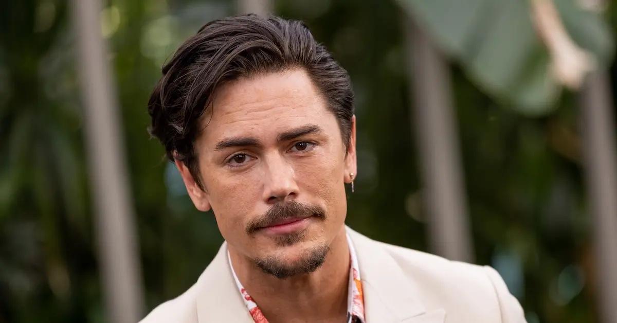 Tom Sandoval at an outdoor event in a white suit