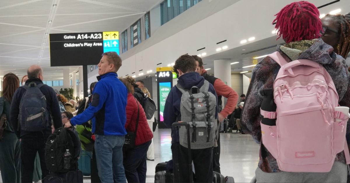 Travelers wait in line at the Newark Liberty International Airport. 
