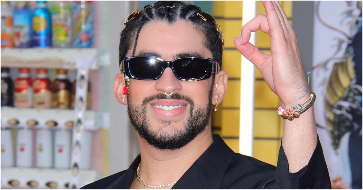 Bad Bunny smiling while wearing sunglasses