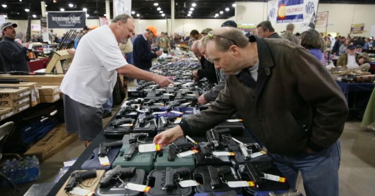 A man bends over to look at guns at t he Tanner Gun Show.