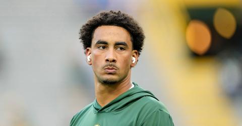 Jordan Love warming up with airpods on.