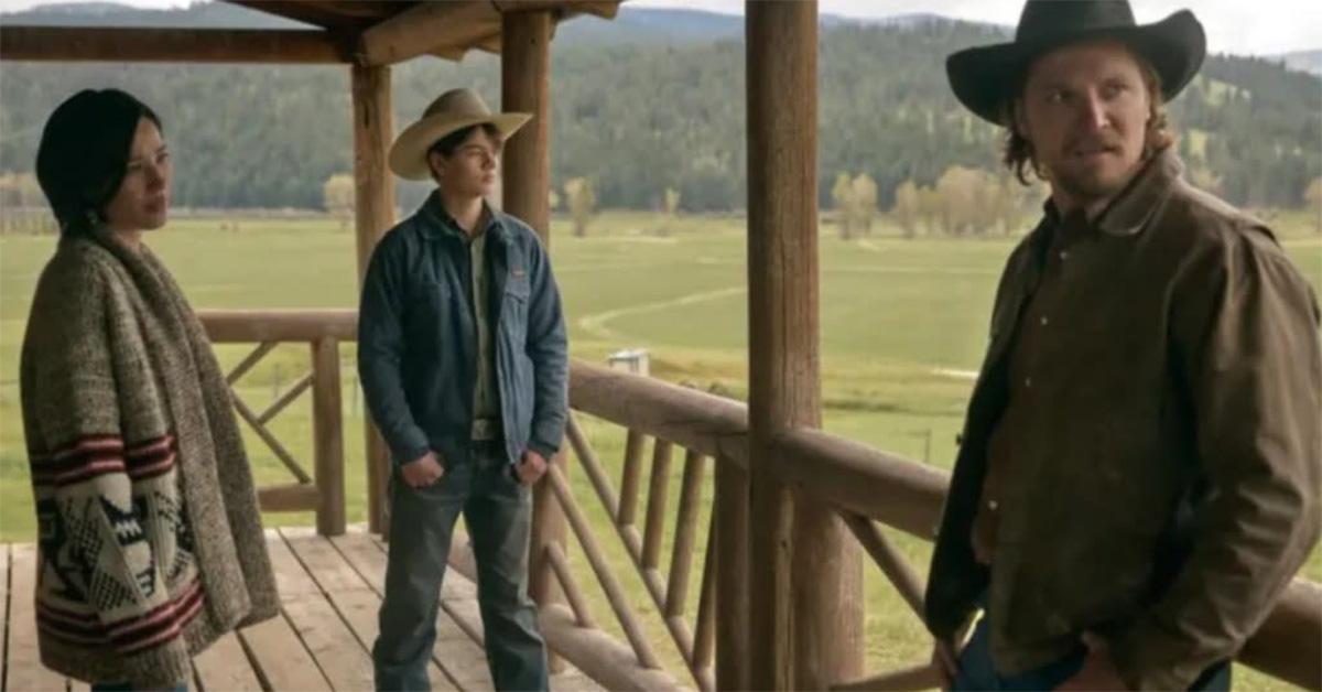 The cast of Yellowstone standing on a porch. 