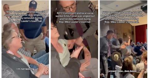 Social worker Emily Feiner carried out of town hall meeting