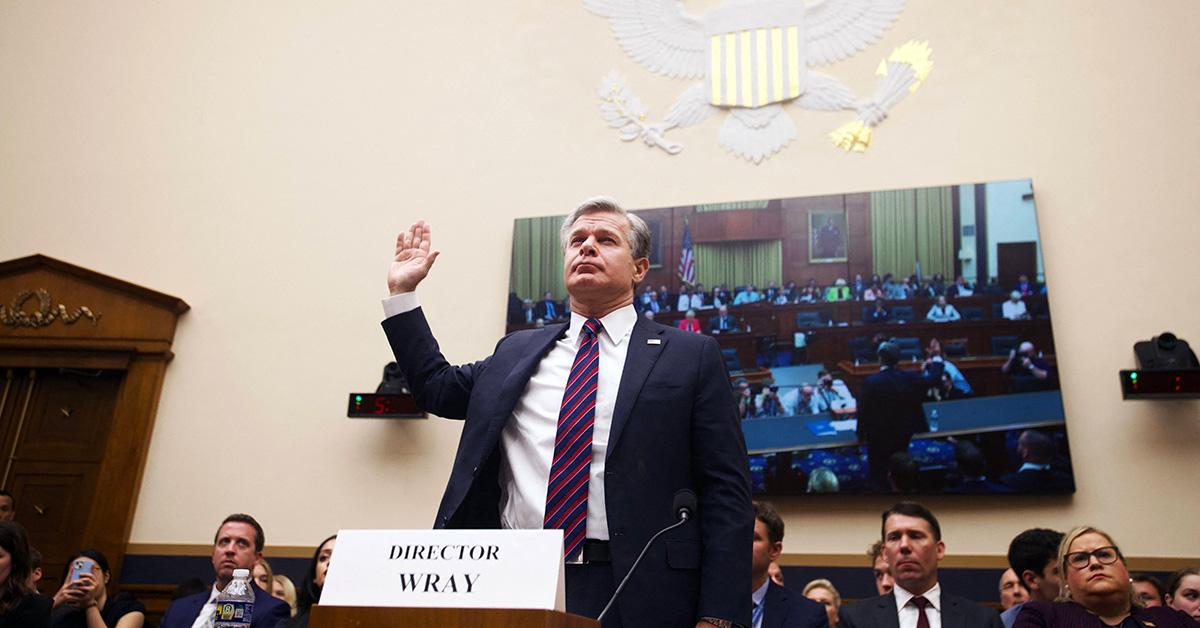 Christopher Wray taking an oath before Congress. 