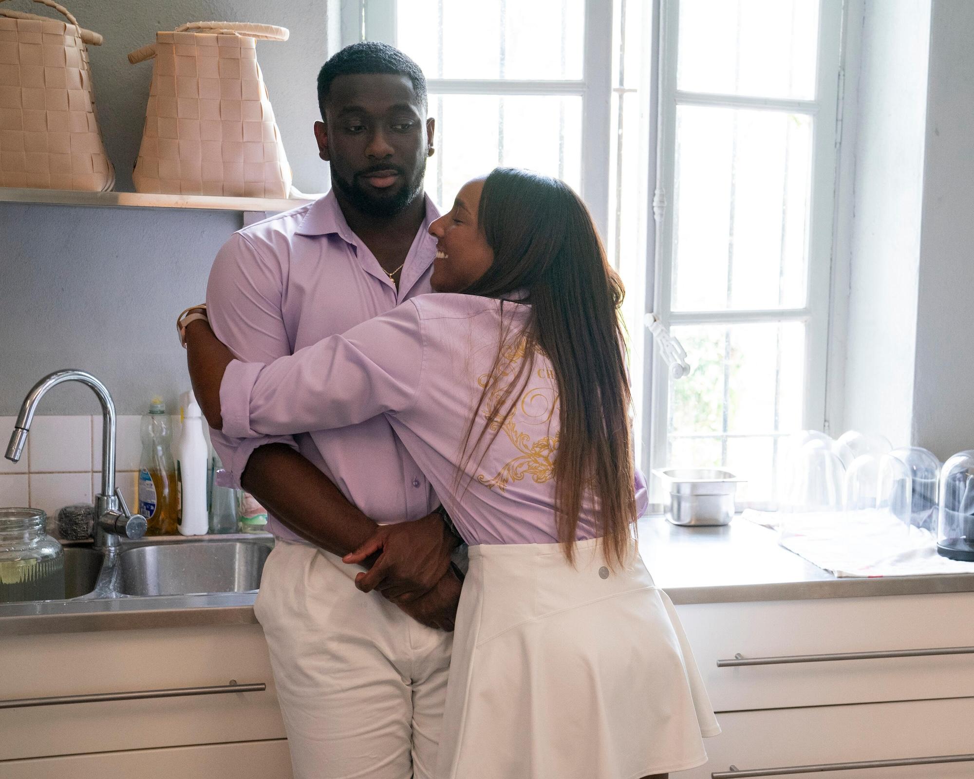 Gabriella Sanon hugging co-star Andre Mitchell in the kitchen